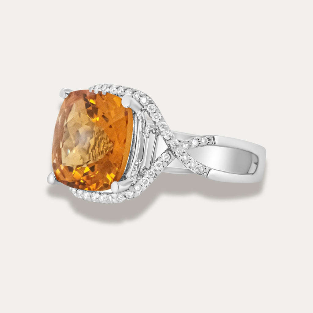 White gold ring with a large yellow citrine gemstone on a light gray background