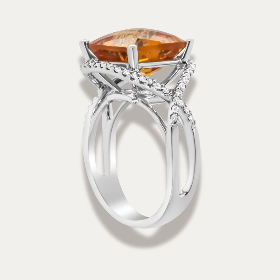 White gold ring with a large yellow citrine gemstone on a light grey background