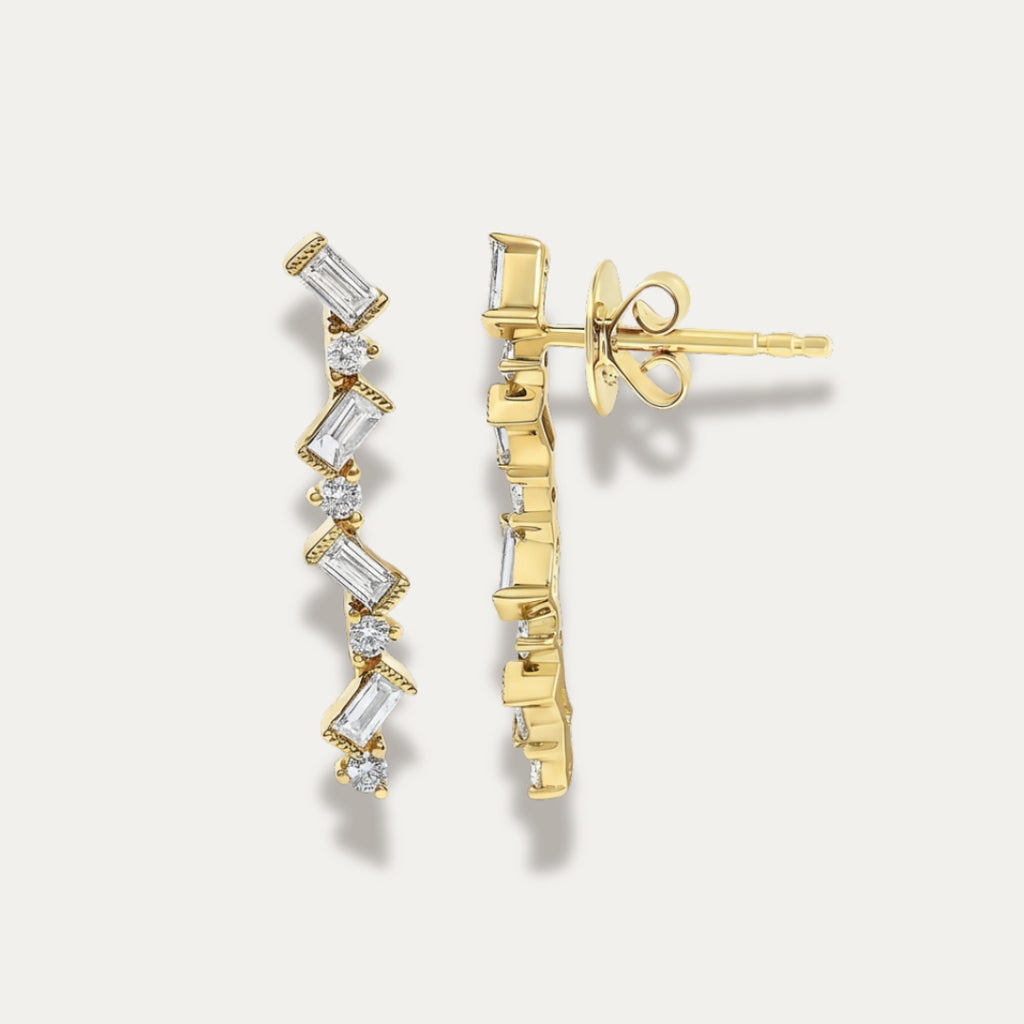 Gold zigzag earrings with diamonds on a light gray background