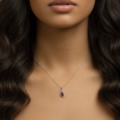 Model wearing the Carmine Teardrop Pendant Necklace by Teraju, featuring a deep red ruby teardrop gemstone set in white gold.