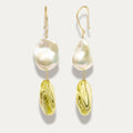Pair of earrings with large pearl and yellow citrine on a light gray background