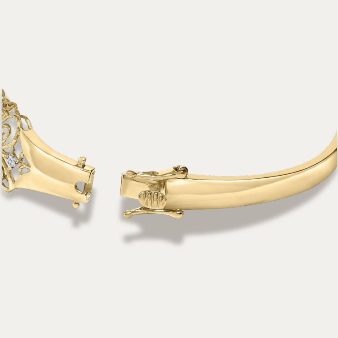 Gold bracelet with intricate design on a light gray background