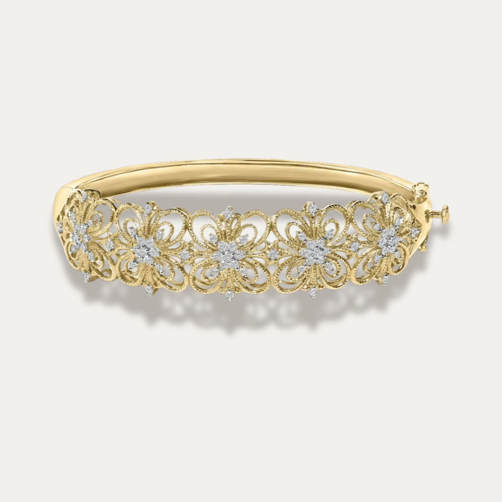 Gold bracelet with floral design and embedded diamonds on a light gray background