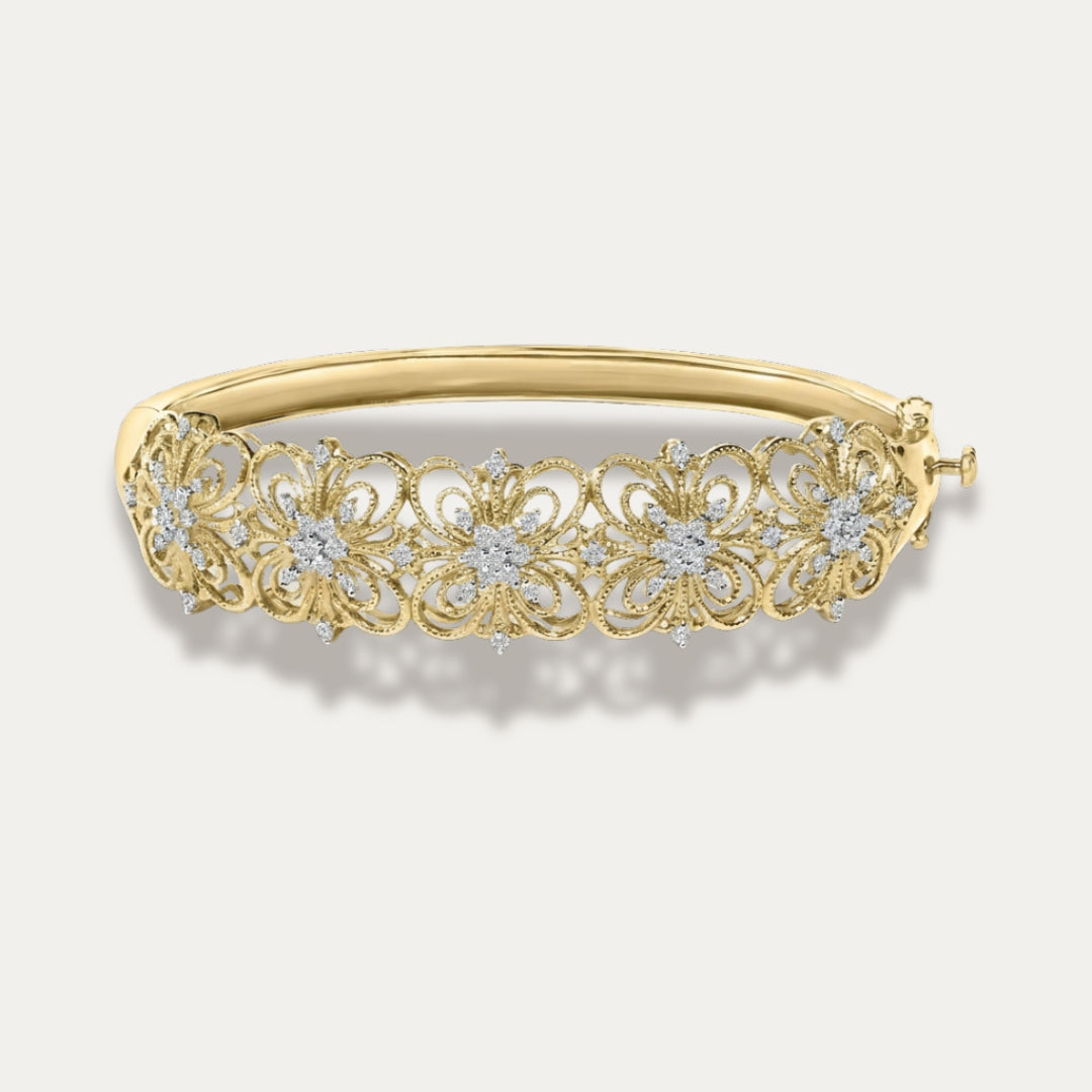 Gold bracelet with floral design and embedded diamonds on a light gray background