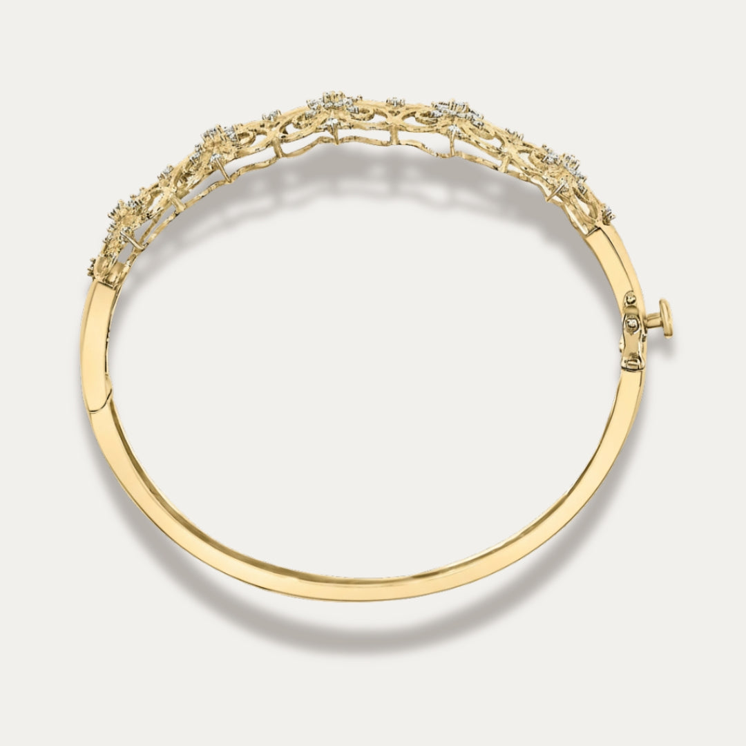 Gold bracelet with intricate design on a light gray background