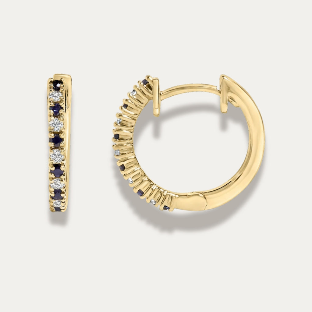 Gold hoop earrings with embedded stones on a light gray background