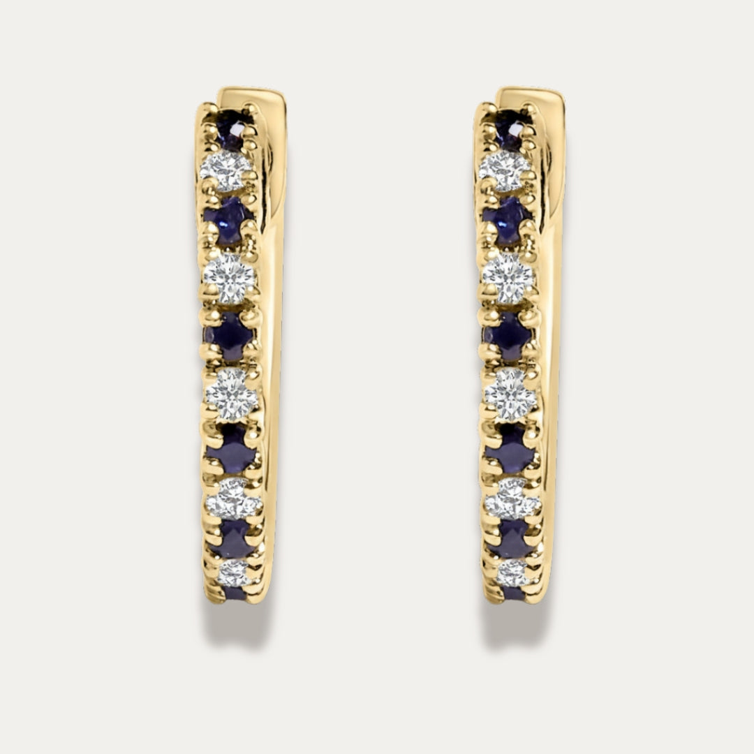 Gold hoop earrings with embedded blue sapphire and diamonds gemstones on a light gray background