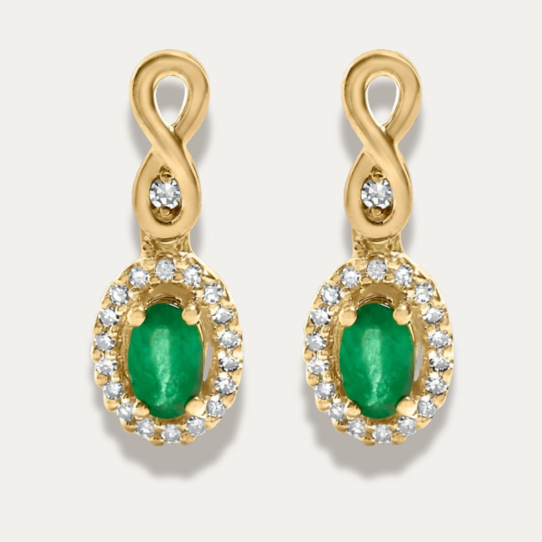 Gold earrings with green gemstones and small diamonds on a white background