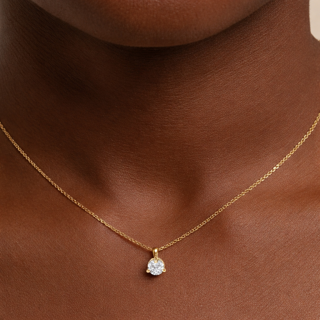 Gold necklace with a diamond pendant on a model
