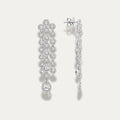 White gold earrings with diamond gemstones on a light gray background