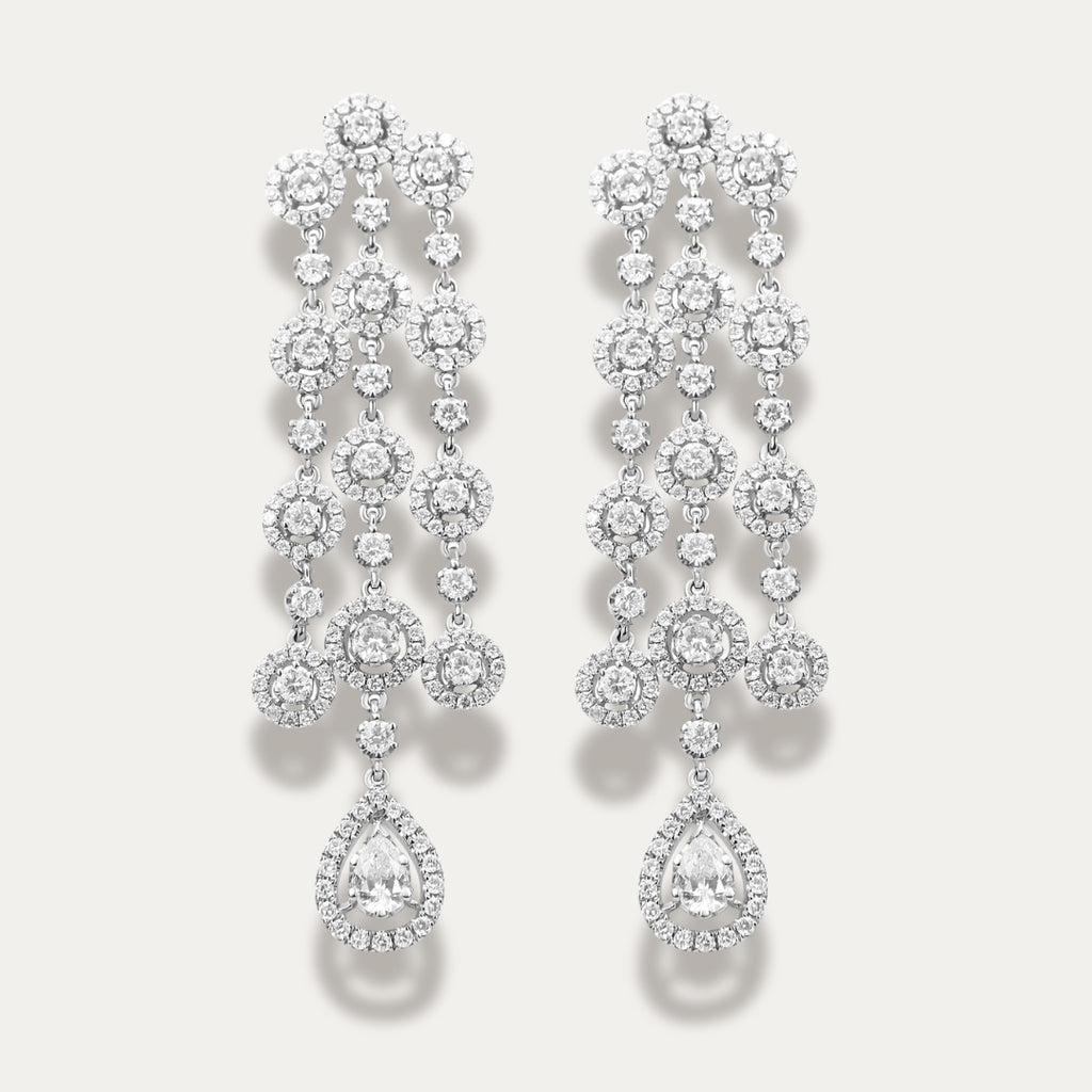 Pair of diamond earrings on a light gray background