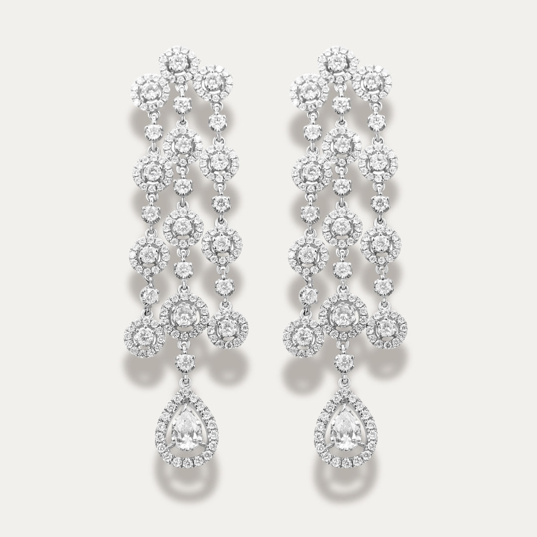 Pair of diamond earrings on a light gray background