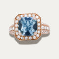 18K Rose Gold Ring with aquamarine gemstone and diamond accents on a light gray background