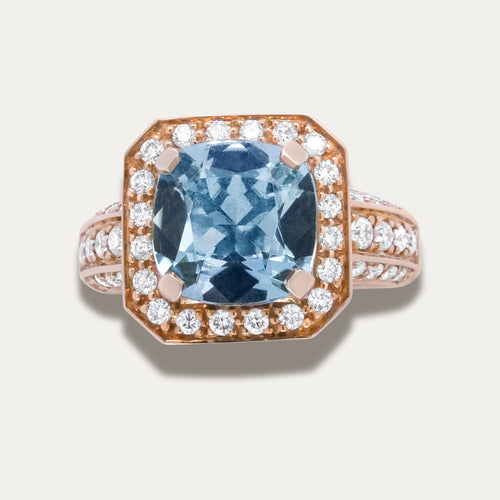 18K Rose Gold Ring with aquamarine gemstone and diamond accents on a light gray background