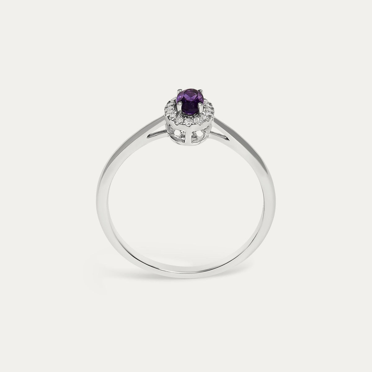 Face view of the Origine birthstone halo ring in 10K white gold with an oval amethyst crowned by a halo of natural diamonds