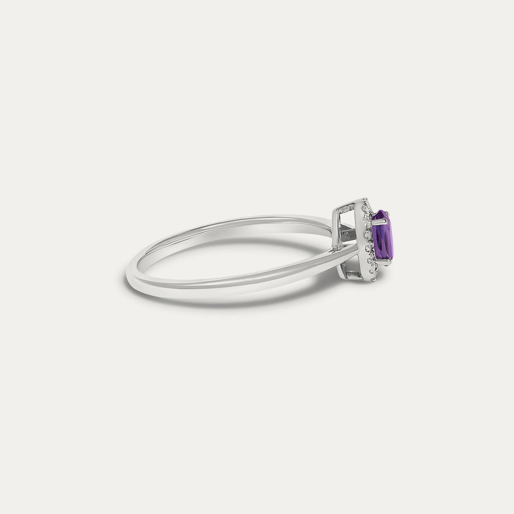 Side view of the Origine birthstone halo ring in 10K white gold with an oval amethyst and a halo of natural diamonds above the slim band