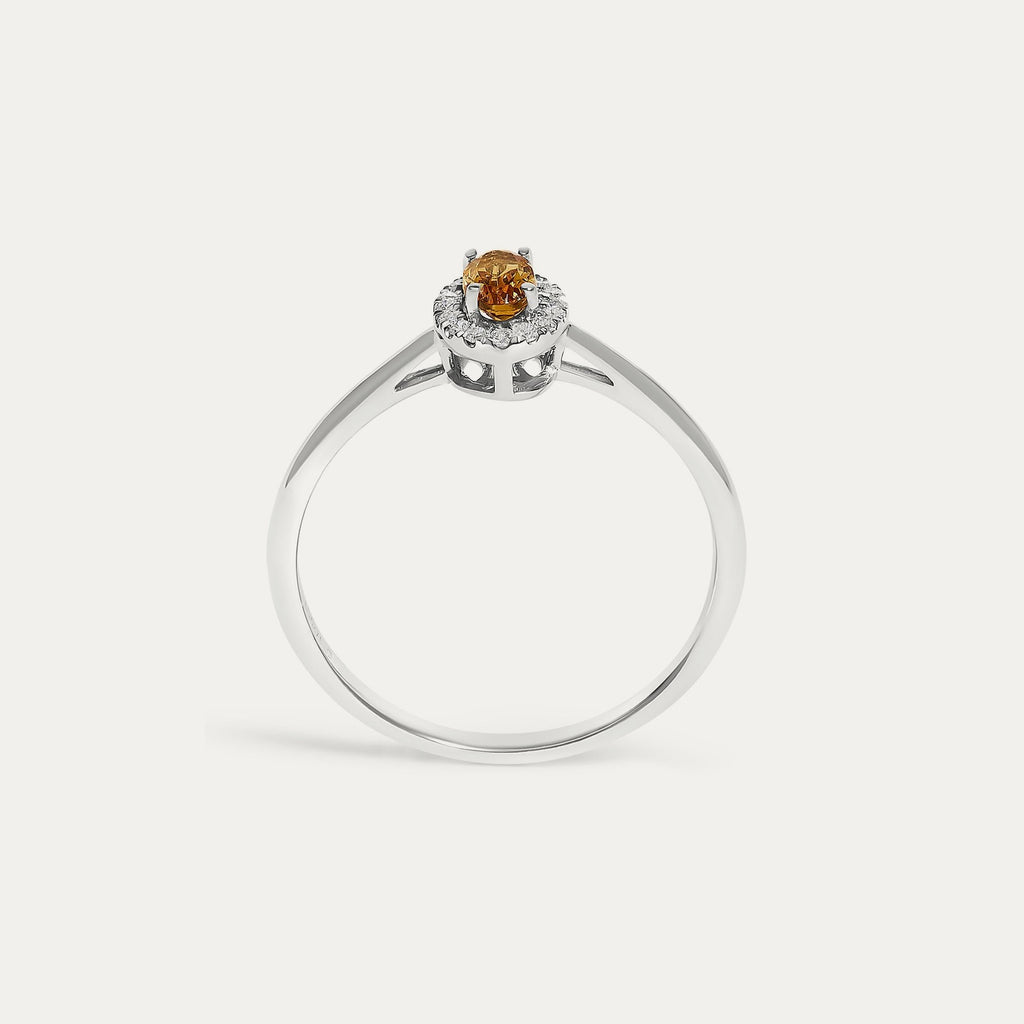 Face view of the Origine birthstone halo ring in 10K white gold with an oval citrine crowned by a halo of natural diamonds
