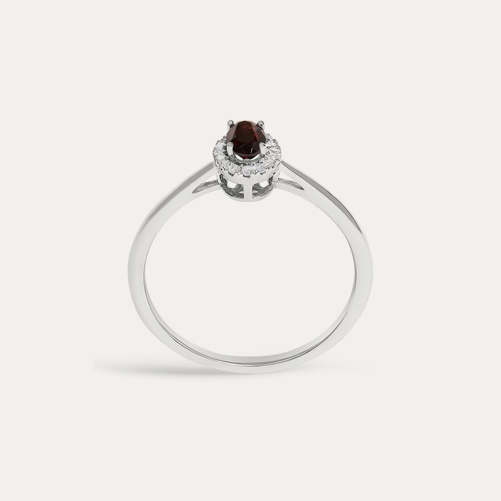 Face view of the Origine birthstone halo ring in 10K white gold with an oval garnet crowned by a halo of natural diamonds