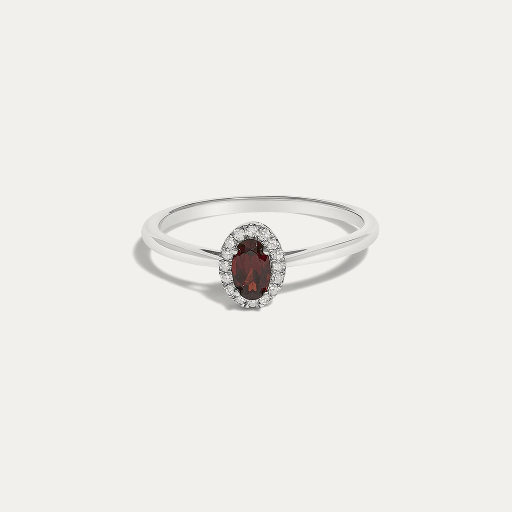 Front view of the Origine birthstone halo ring in 10K white gold with an oval garnet crowned by a halo of natural diamonds