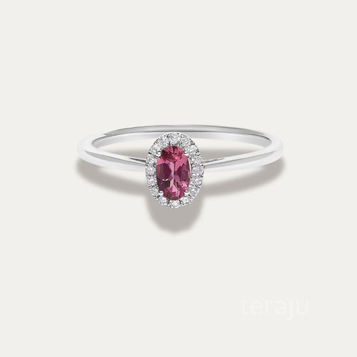 Front view of the Origine birthstone halo ring in 10K white gold with an oval pink tourmaline crowned by a halo of natural diamonds