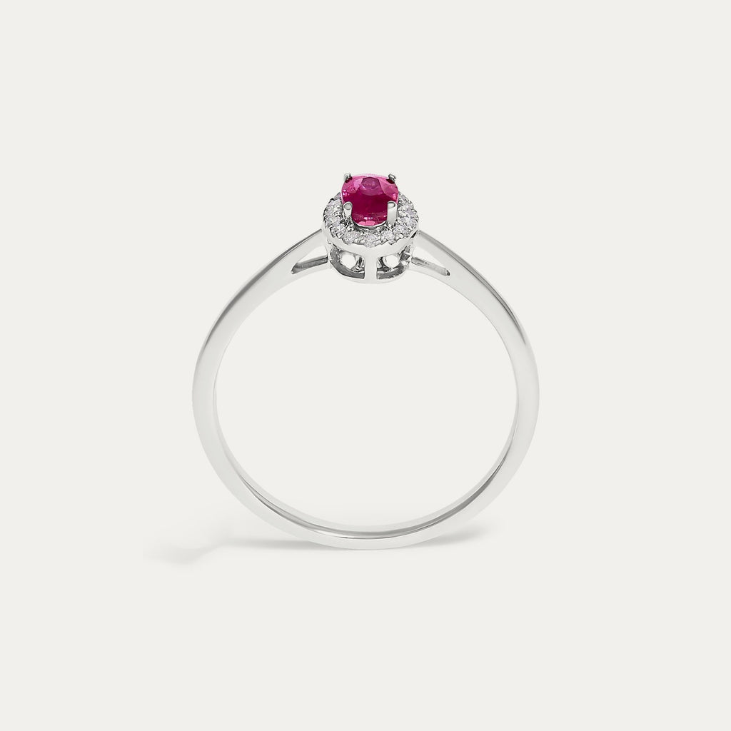 Face view of the Origine birthstone halo ring in 10K white gold with an oval ruby crowned by a halo of natural diamonds