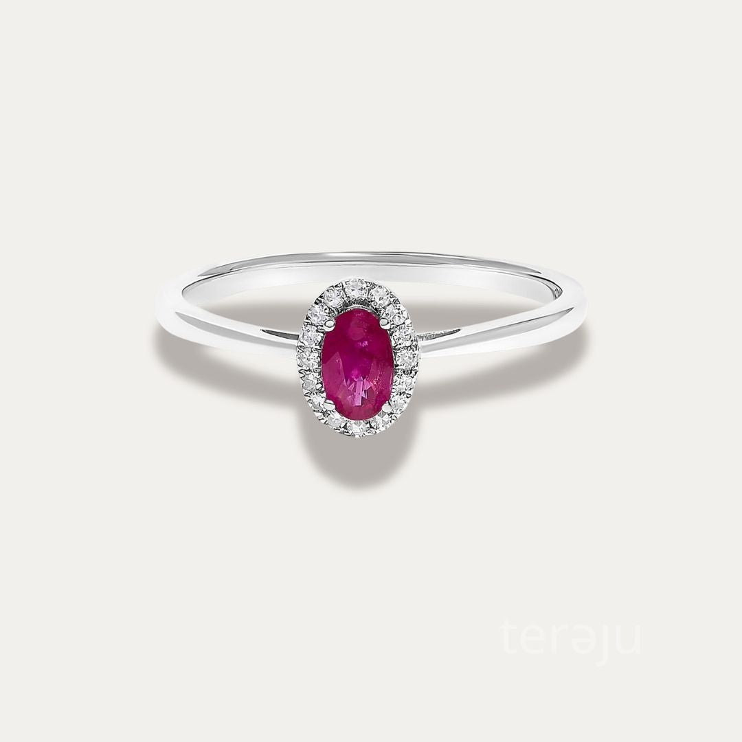 Front view of the Origine birthstone halo ring in 10K white gold with an oval ruby crowned by a halo of natural diamonds