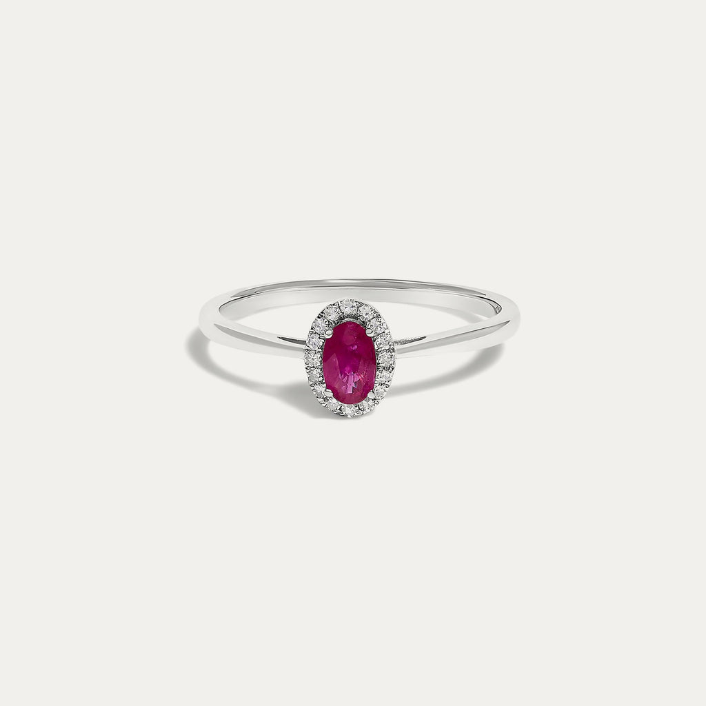 Front view of the Origine birthstone halo ring in 10K white gold with an oval ruby crowned by a halo of natural diamonds