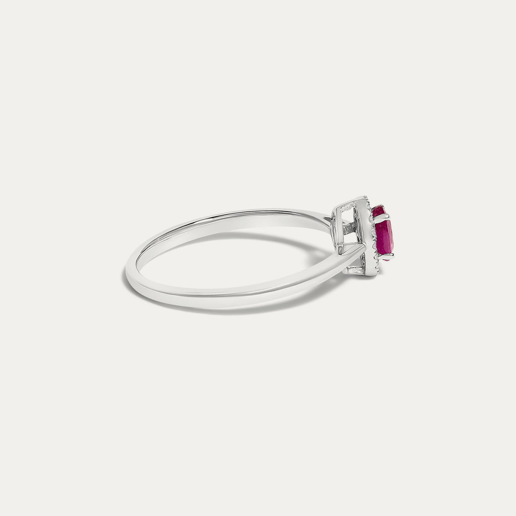 Side view of the Origine birthstone halo ring in 10K white gold with an oval ruby and a halo of natural diamonds above the slim band