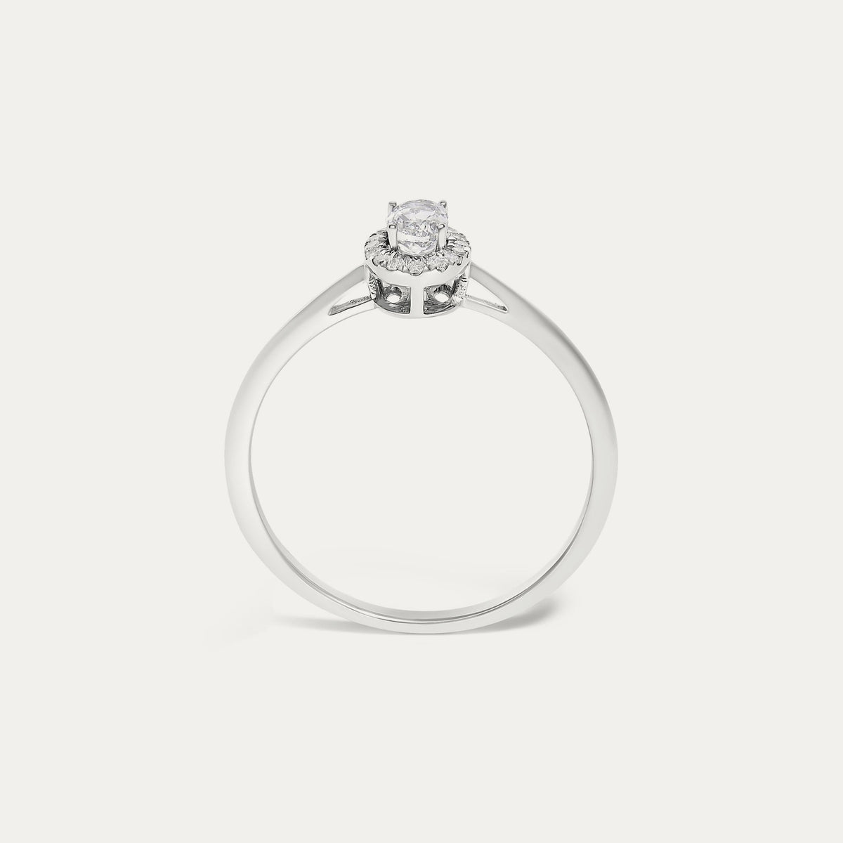 Face view of the Origine birthstone halo ring in 10K white gold with an oval white topaz crowned by a halo of natural diamonds