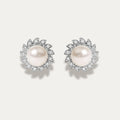 Pair of pearl earrings with diamonds on a light gray background