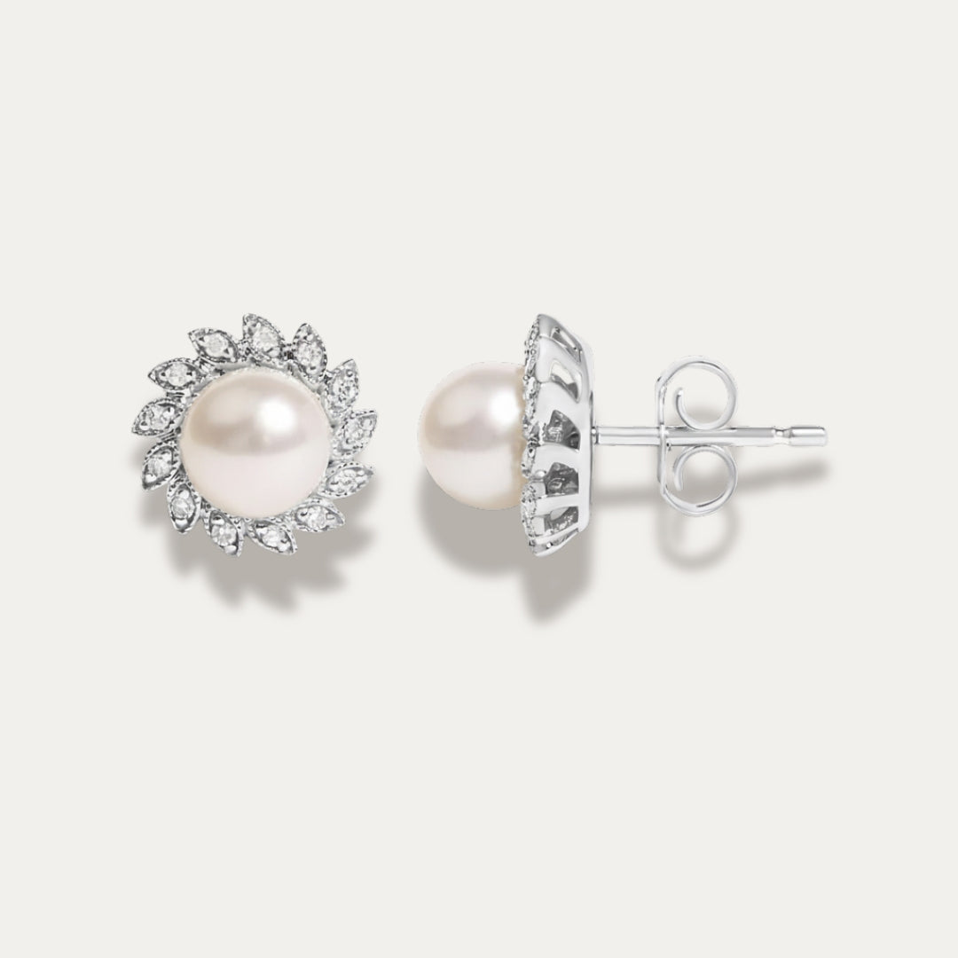 Pearl earrings with diamond accents on a white background
