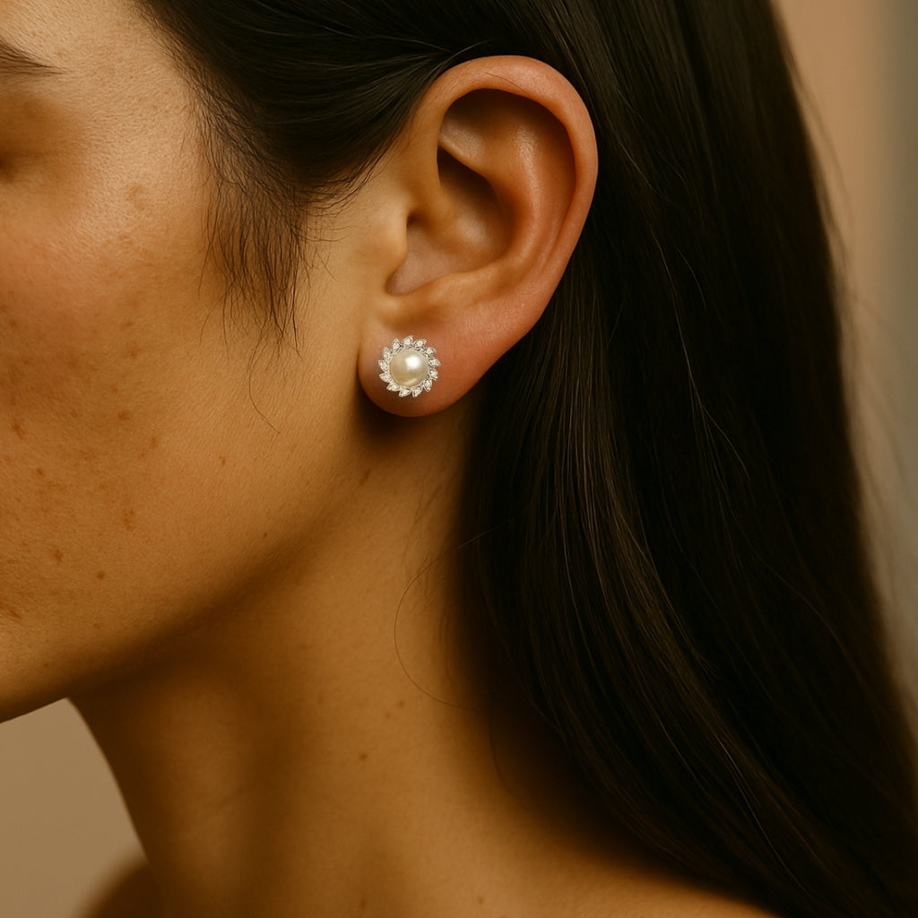 woman wearing pearl with diamond accent earring on a beige background