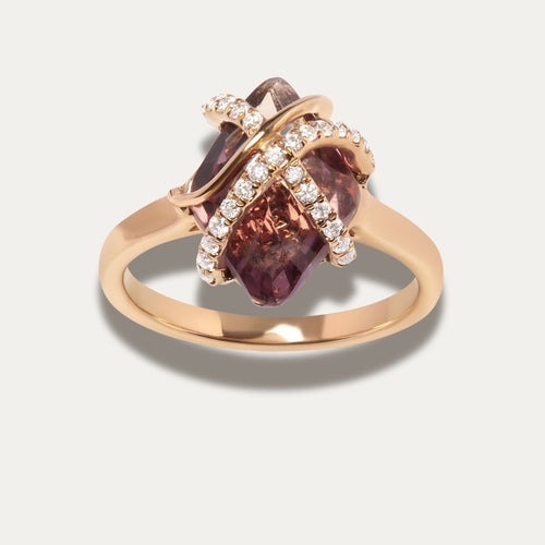 Rose gold ring with purple amethyst gemstone and small diamonds on a light gray background