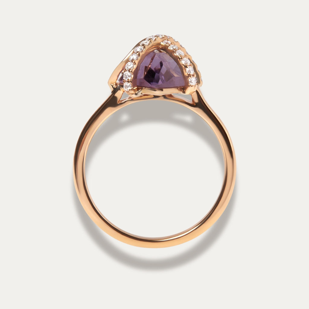 Rose gold ring with a purple amethyst gemstone on a light gray background