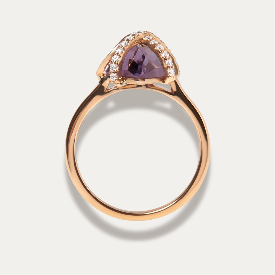 Rose gold ring with a purple amethyst gemstone on a light gray background
