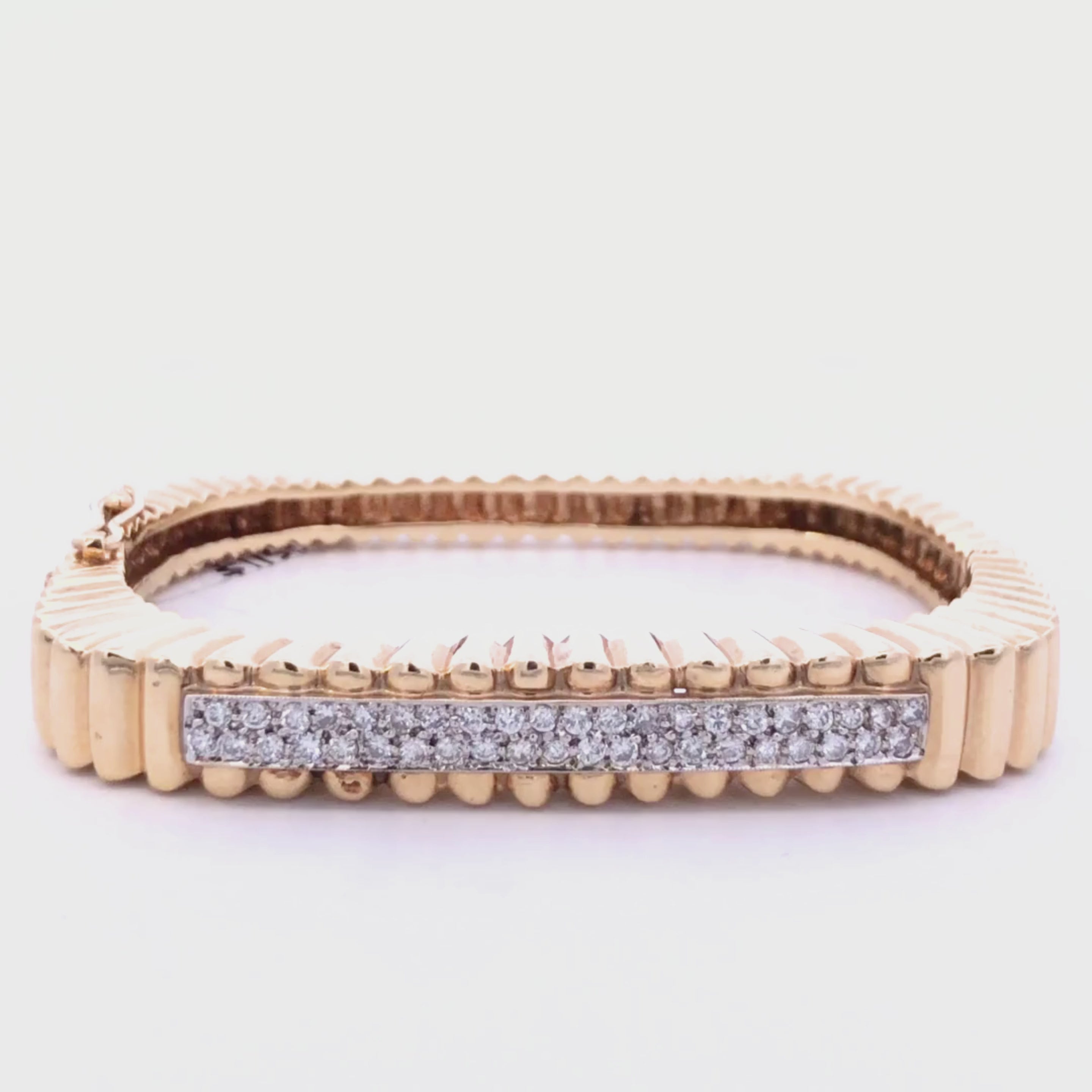 Gold diamond bracelet on a light gray background