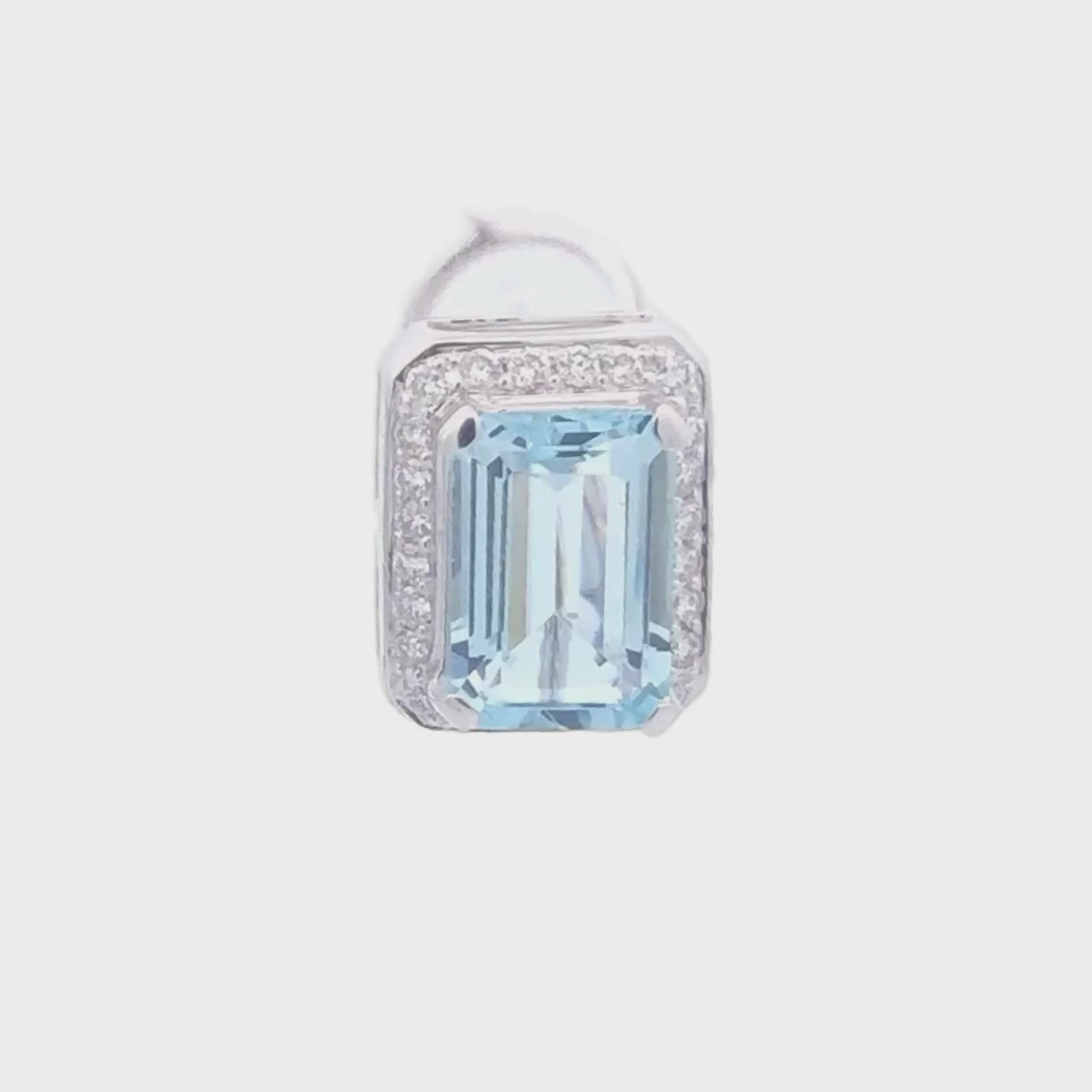 video of a pair of emerald-cut aquamarine gemstone 18K white gold earrings with diamond accents on a white background