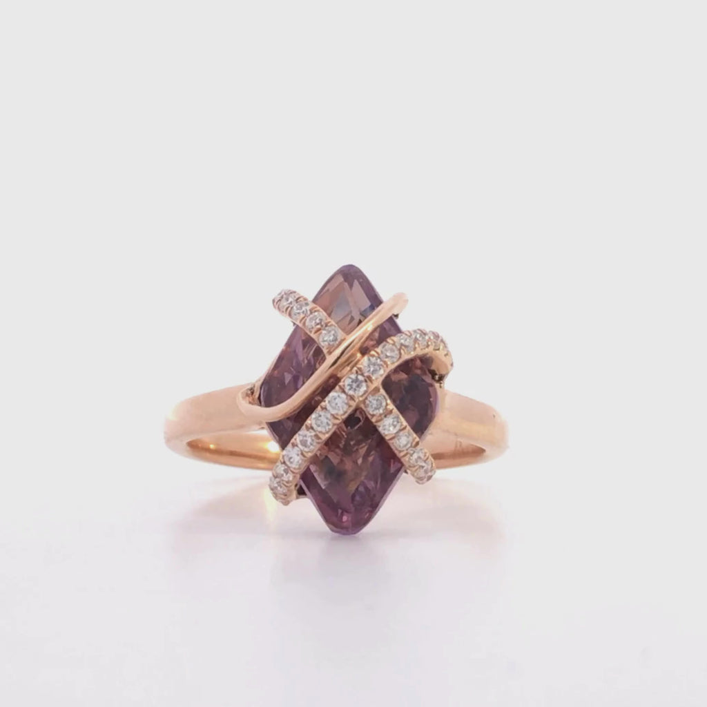 video of a rose gold ring with a purple amethyst gemstone and diamonds on a light gray background